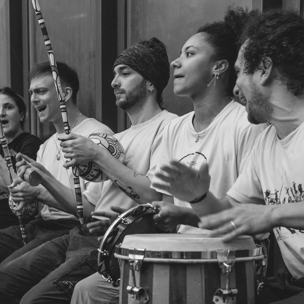 Bateria: Musiker:innen mit Berimbaus und Atabaque